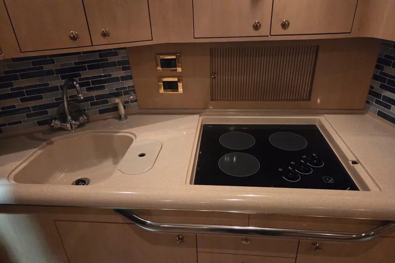 Slide: The Image of Kitchen area of 2000 Sea Ray 410 Sundancer with sink and stovetop. - 26