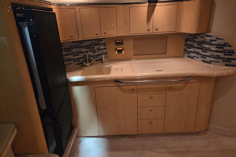 Slide: The Image of Luxurious kitchen area in a 2000 Sea Ray 410 Sundancer yacht with modern cabinetry. - 30