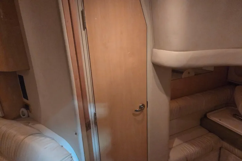 Slide: The Image of Interior cabin of 2000 Sea Ray 410 Sundancer yacht with wooden door and seating. - 32