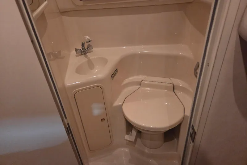 Slide: The Image of Compact bathroom in 2000 Sea Ray 410 Sundancer yacht with toilet and sink. - 33