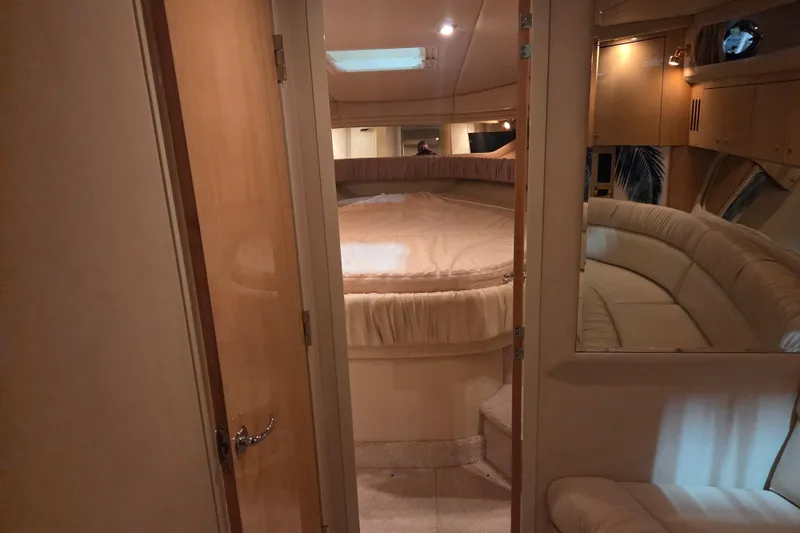 Slide: The Image of Interior of 2000 Sea Ray 410 Sundancer yacht, featuring cozy cabin and seating area. - 34