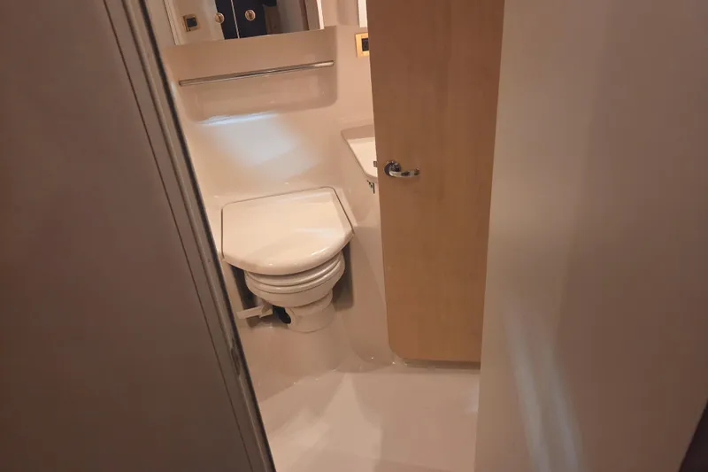 Slide: The Image of Bathroom interior of 2000 Sea Ray 410 Sundancer yacht, featuring toilet and sink. - 38