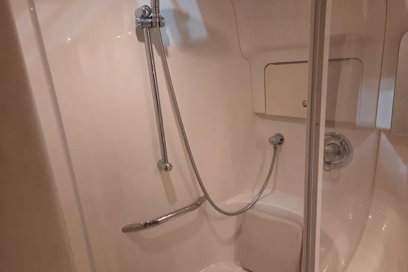 Slide: The Image of Shower area in 2000 Sea Ray 410 Sundancer yacht, featuring chrome fixtures and white interior. - 40