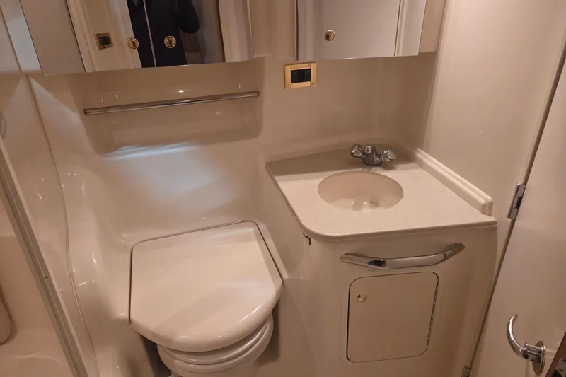 Slide: The Image of Bathroom interior of 2000 Sea Ray 410 Sundancer yacht, featuring sink and toilet. - 41