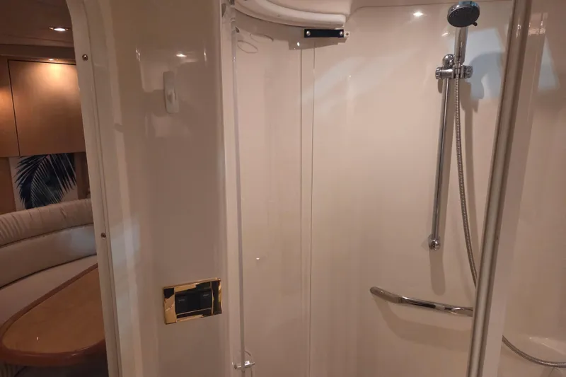 Slide: The Image of Shower area inside 2000 Sea Ray 410 Sundancer yacht, featuring modern fixtures and seating. - 42