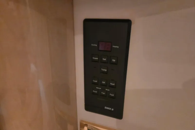 Slide: The Image of Control panel of a 2000 Sea Ray 410 Sundancer boat, featuring temperature settings. - 44