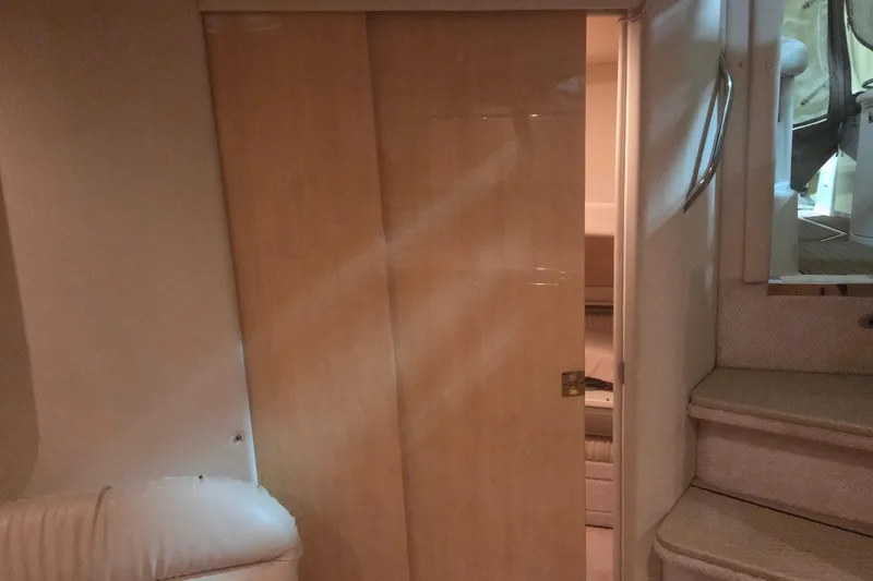 Slide: The Image of Interior of 2000 Sea Ray 410 Sundancer with wooden sliding door and carpeted stairs. - 46