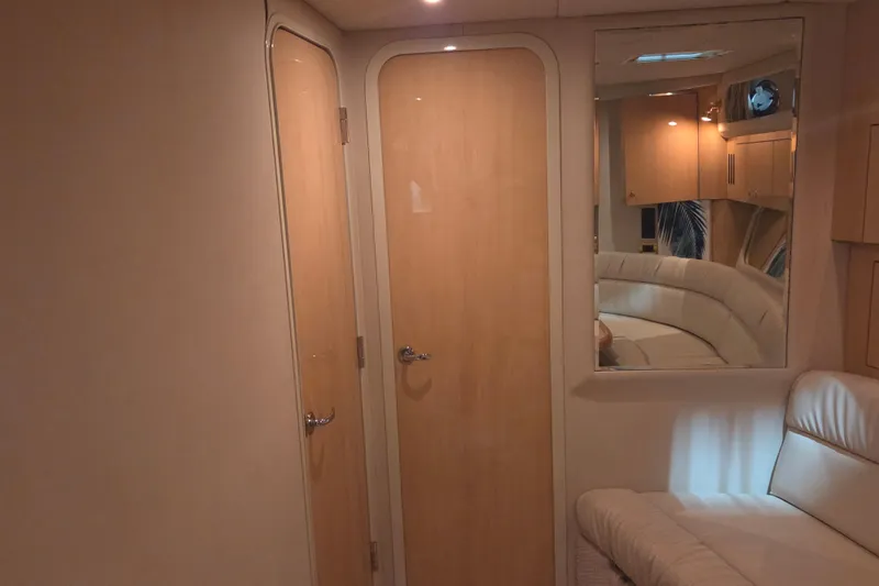 Slide: The Image of Interior of 2000 Sea Ray 410 Sundancer yacht with wooden doors and plush seating. - 47