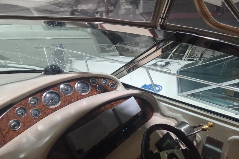 Slide: The Image of Interior view of 2000 Sea Ray 410 Sundancer yacht dashboard with gauges and controls. - 49