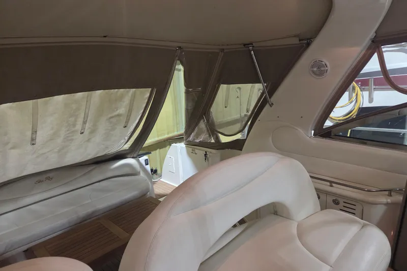 Slide: The Image of Interior of 2000 Sea Ray 410 Sundancer with beige seating and wood accents. - 55