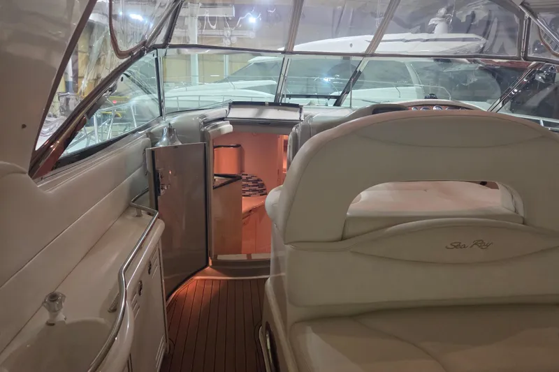 Slide: The Image of Interior of 2000 Sea Ray 410 Sundancer yacht with luxurious seating and helm. - 56