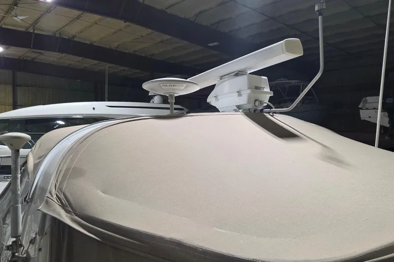 Slide: The Image of 2000 Sea Ray 410 Sundancer with radar equipment in a covered storage area. - 58