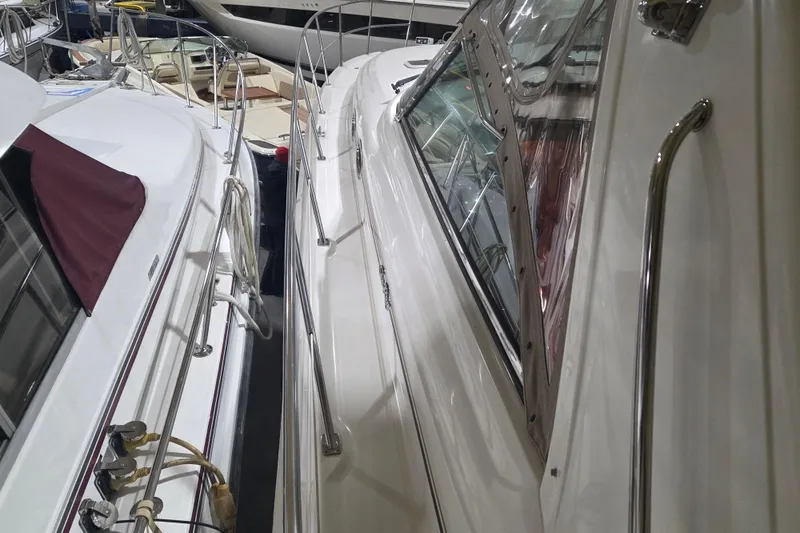 Slide: The Image of 2000 Sea Ray 410 Sundancer yacht docked alongside another boat in a marina. - 59