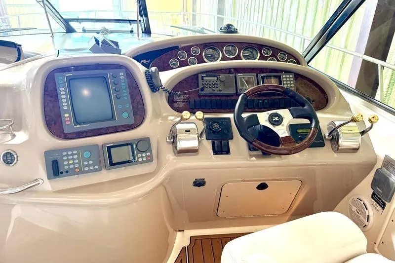 Slide: The Image of Cockpit of 2000 Sea Ray 410 Sundancer with navigation and control instruments. - 6