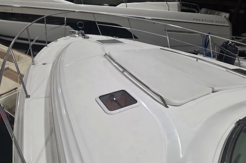 Slide: The Image of 2000 Sea Ray 410 Sundancer yacht deck with sleek design and railing. - 60