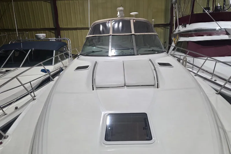 Slide: The Image of 2000 Sea Ray 410 Sundancer yacht in storage, showcasing sleek design and spacious deck. - 63