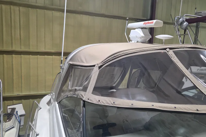 Slide: The Image of 2000 Sea Ray 410 Sundancer boat with beige canopy and Raytheon radar in storage. - 64