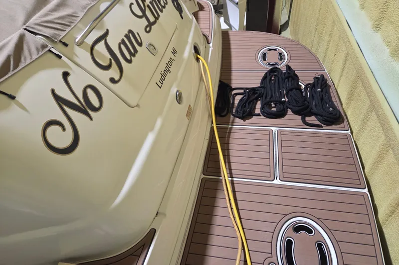 Slide: The Image of 2000 Sea Ray 410 Sundancer boat with deck, ropes, and Ludington, MI label. - 66