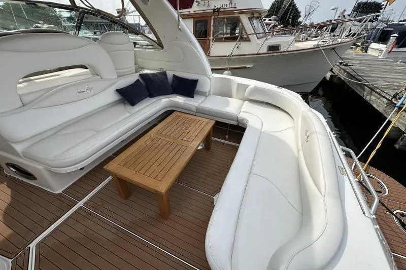 Slide: The Image of Luxurious 2000 Sea Ray 410 Sundancer yacht with spacious white seating and wooden table. - 7