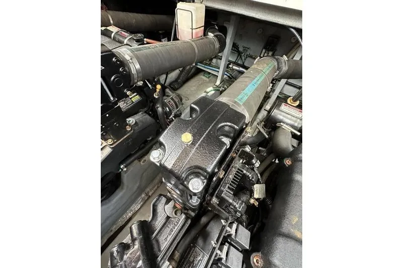 Slide: The Image of Engine compartment of a 2000 Sea Ray 410 Sundancer boat, showcasing mechanical components. - 72