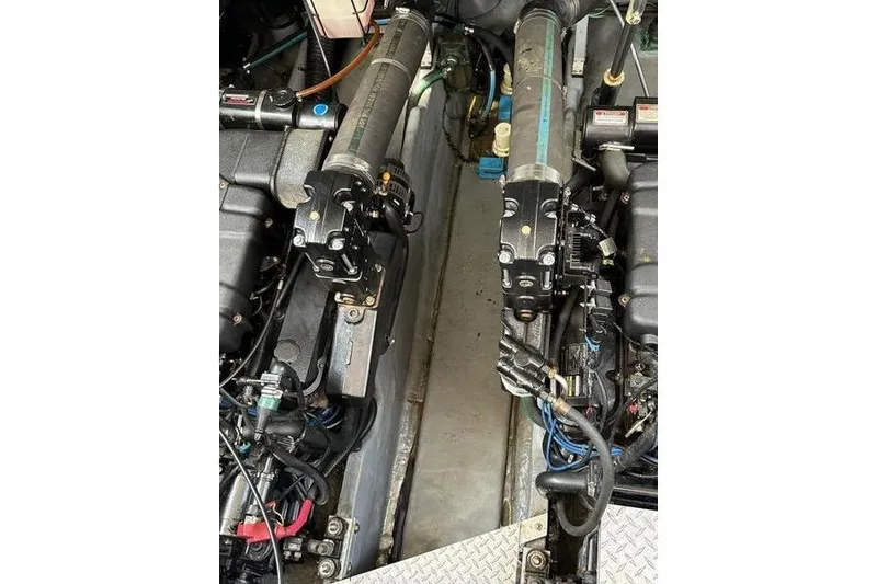 Slide: The Image of Engine compartment of a 2000 Sea Ray 410 Sundancer boat, showcasing mechanical components. - 73