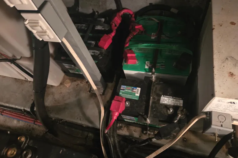 Slide: The Image of Battery compartment of a 2000 Sea Ray 410 Sundancer boat with visible wiring. - 75