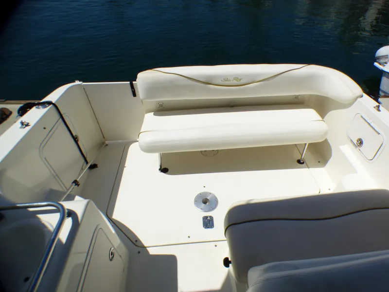 Slide: The Image of 2003 Sea Ray 260 Sundancer boat interior with white seating and open deck area. - 12