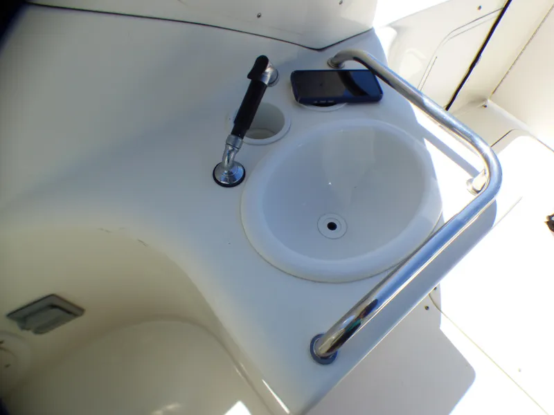 Slide: The Image of 2003 Sea Ray 260 Sundancer boat sink with faucet and railing. - 13