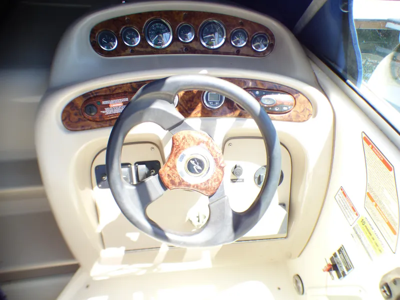Slide: The Image of Steering wheel and dashboard of 2003 Sea Ray 260 Sundancer boat. - 17