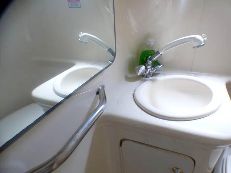 Slide: The Image of 2003 Sea Ray 260 Sundancer bathroom sink with mirror and faucet. - 26
