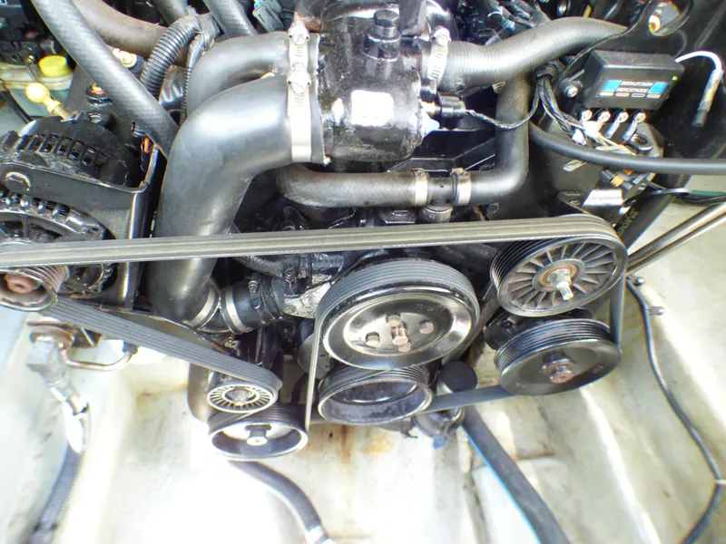 Slide: The Image of Engine of 2003 Sea Ray 260 Sundancer boat, showing belts and pulleys. - 33