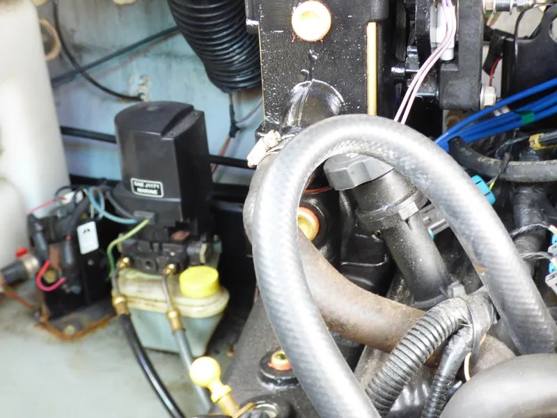Slide: The Image of Engine compartment of a 2003 Sea Ray 260 Sundancer boat, showing mechanical components and wiring. - 34