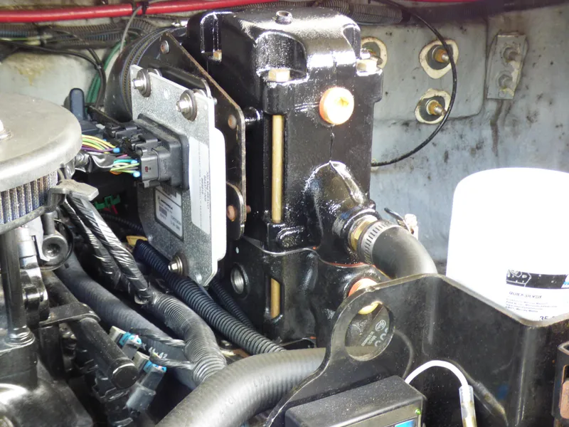 Slide: The Image of Engine compartment of a 2003 Sea Ray 260 Sundancer boat, showing mechanical components and wiring. - 35