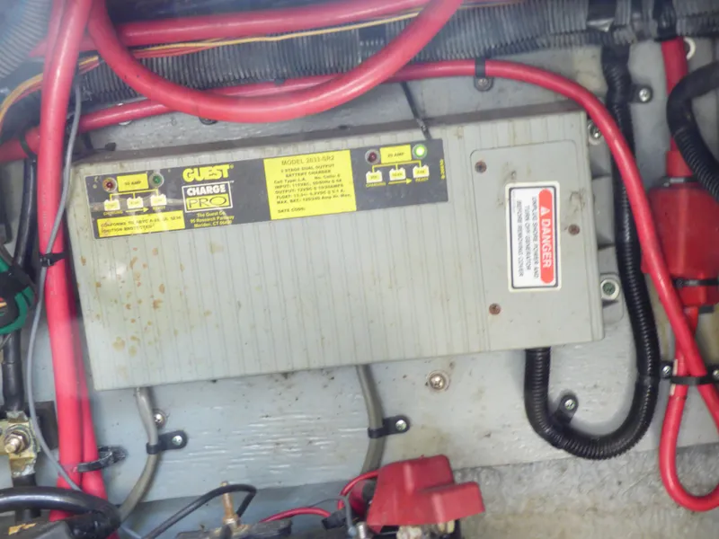 Slide: The Image of Battery charger in a 2003 Sea Ray 260 Sundancer boat with red cables. - 37