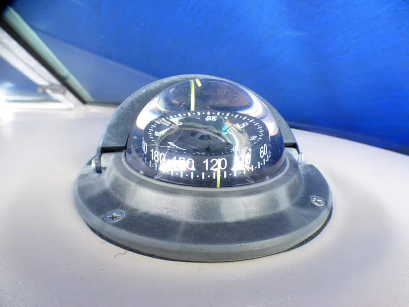 Slide: The Image of Compass on 2003 Sea Ray 260 Sundancer boat dashboard, under blue canopy. - 40