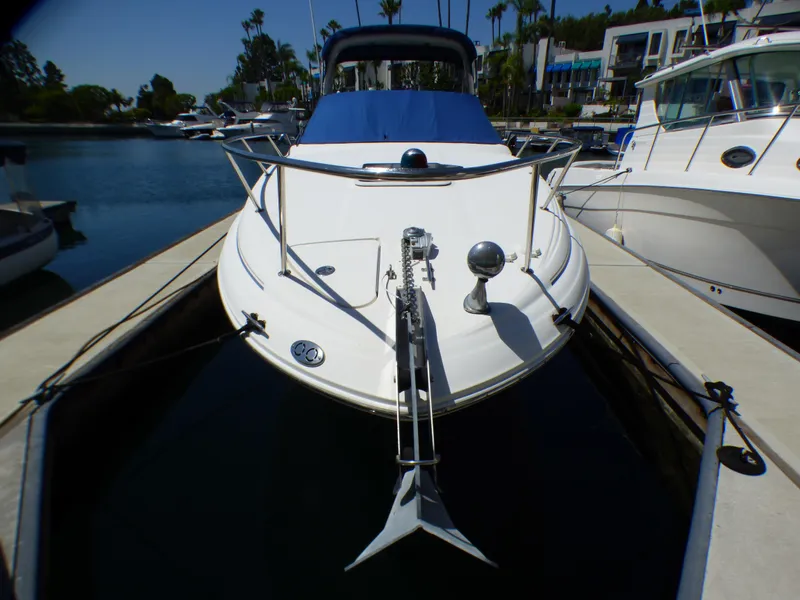 Slide: The Image of 2003 Sea Ray 260 Sundancer docked at marina, front view. - 7