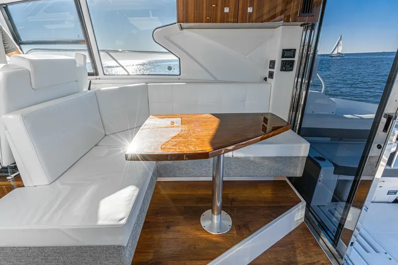 Slide: The Image of Luxurious interior of 2023 Cruisers Yachts 42 Cantius with elegant seating and ocean view. - 16