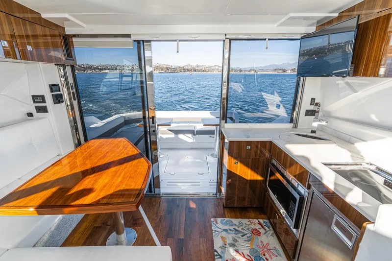 Slide: The Image of Luxurious interior of 2023 Cruisers Yachts 42 Cantius with modern kitchen and scenic ocean view. - 18