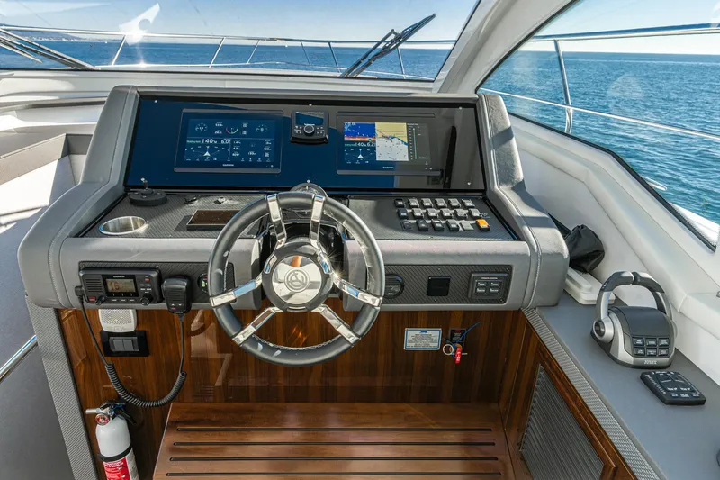 Slide: The Image of Helm of 2023 Cruisers Yachts 42 Cantius with advanced navigation displays and controls. - 22