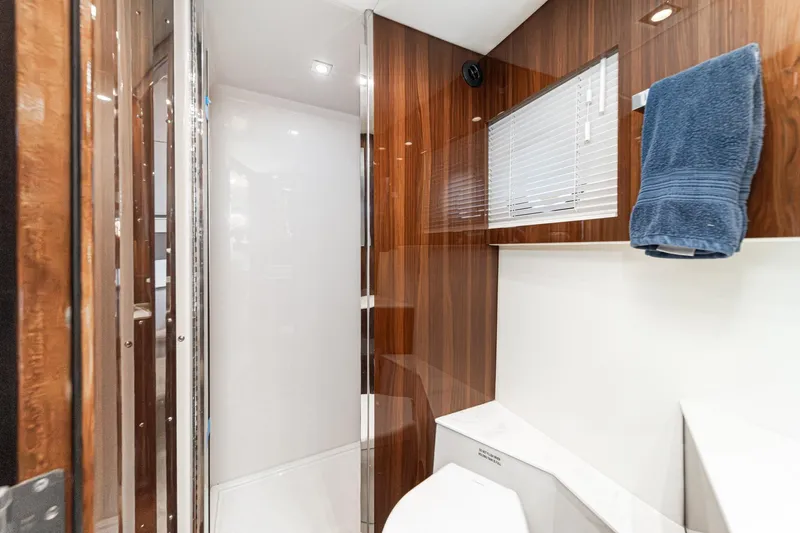 Slide: The Image of Luxurious bathroom in 2023 Cruisers Yachts 42 Cantius with wood paneling and modern fixtures. - 32
