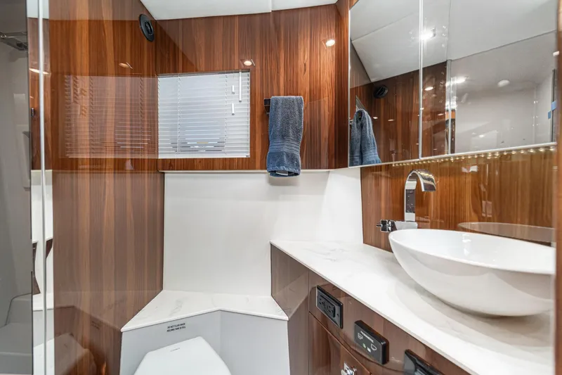 Slide: The Image of Luxurious bathroom in 2023 Cruisers Yachts 42 Cantius with modern fixtures and wood accents. - 33