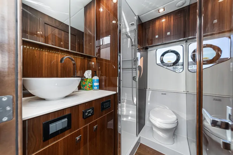Slide: The Image of Luxurious bathroom in 2023 Cruisers Yachts 42 Cantius, featuring modern fixtures and elegant wood finishes. - 38