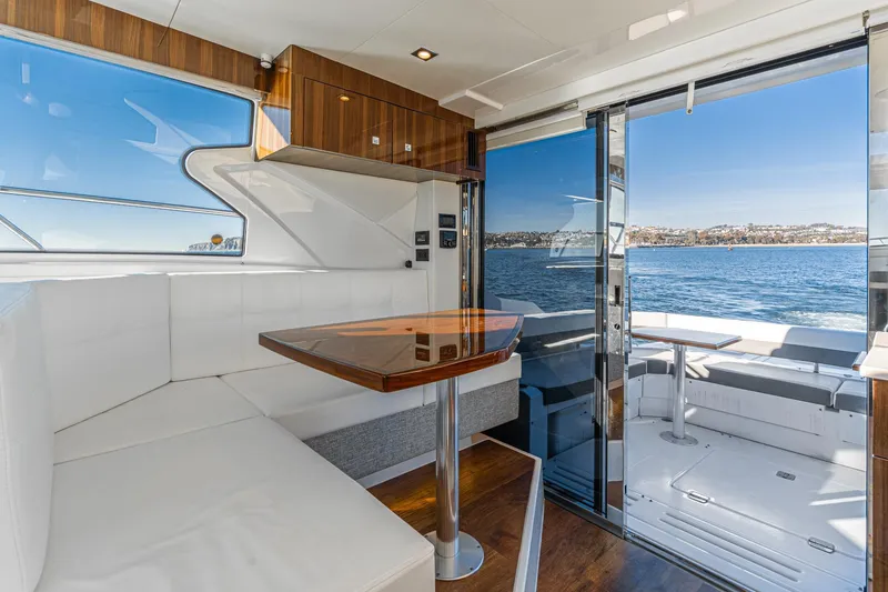 Slide: The Image of Interior of 2023 Cruisers Yachts 42 Cantius with ocean view through glass doors. - 15