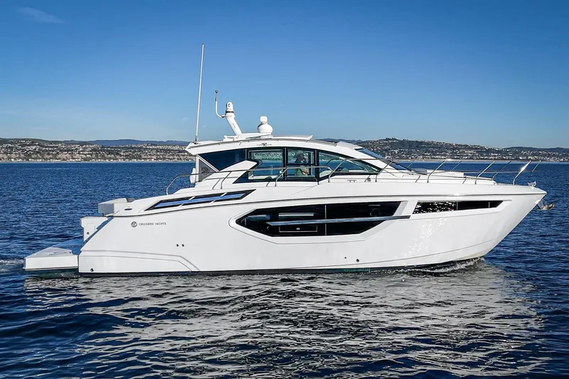 Slide: The Image of 2023 Cruisers Yachts 42 Cantius on open water, sleek design, sunny day. - 2