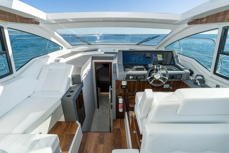 Slide: The Image of 2023 Cruisers Yachts 42 Cantius helm with modern controls and luxurious seating. - 20