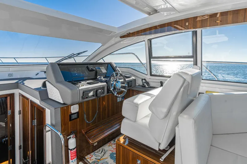 Slide: The Image of Luxurious 2023 Cruisers Yachts 42 Cantius helm with ocean view and modern controls. - 21