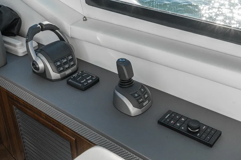 Slide: The Image of Control panel of 2023 Cruisers Yachts 42 Cantius with joystick and throttle controls. - 25