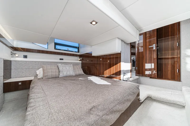 Slide: The Image of Luxurious interior of 2023 Cruisers Yachts 42 Cantius, featuring elegant wood finishes and modern design. - 35