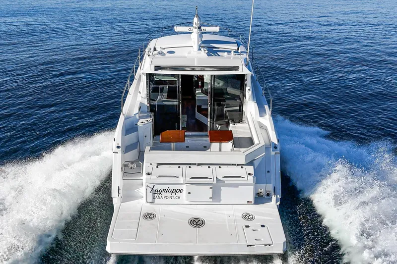 Slide: The Image of 2023 Cruisers Yachts 42 Cantius cruising on open water, rear view. - 8