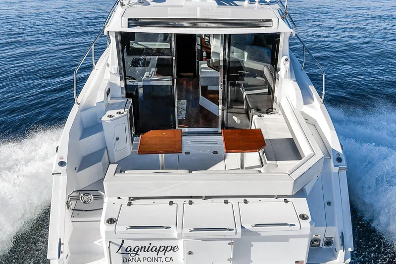 Slide: The Image of 2023 Cruisers Yachts 42 Cantius cruising on open water, rear view. - 9